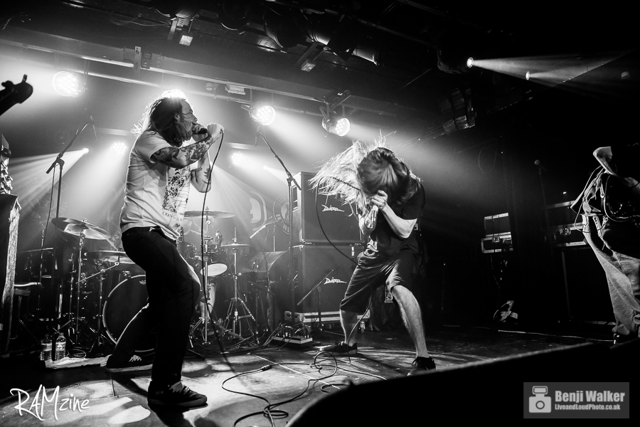 Liam of Cancer Bats on stage with Incite. 